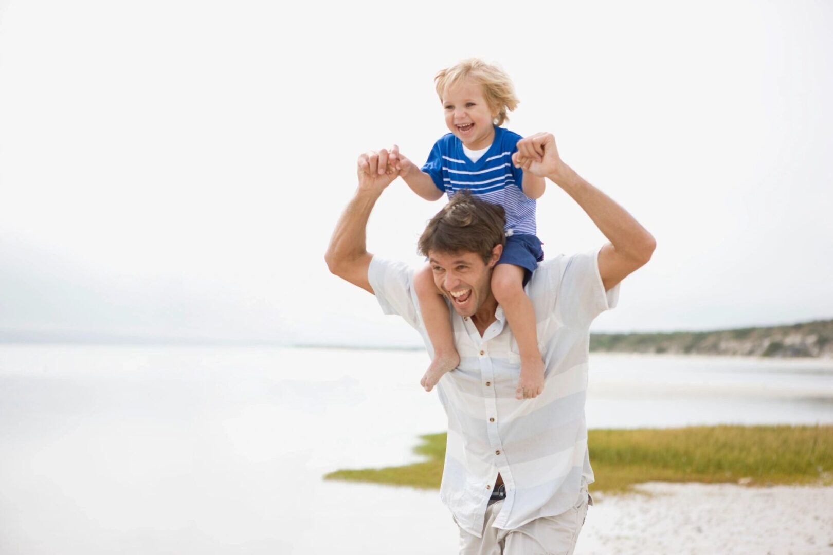 A man carrying his son on his shoulders.