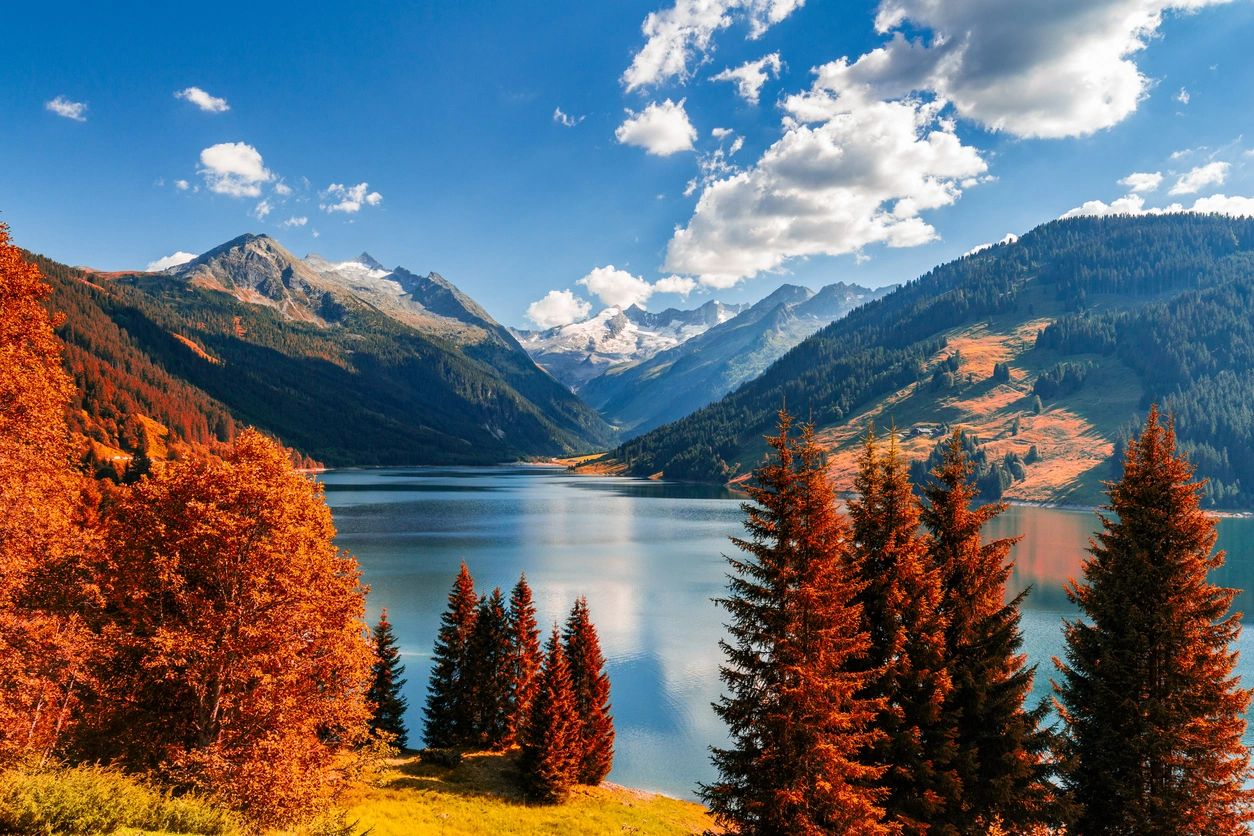 A lake with mountains in the background and trees