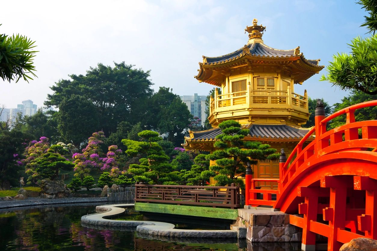 A pagoda sits in the middle of a garden.