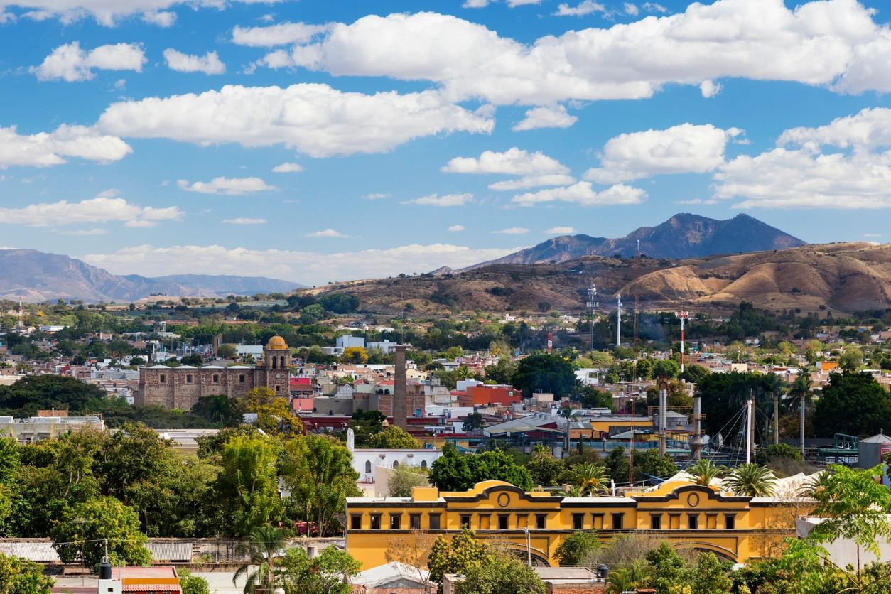 A view of the city from above, with mountains in the background.